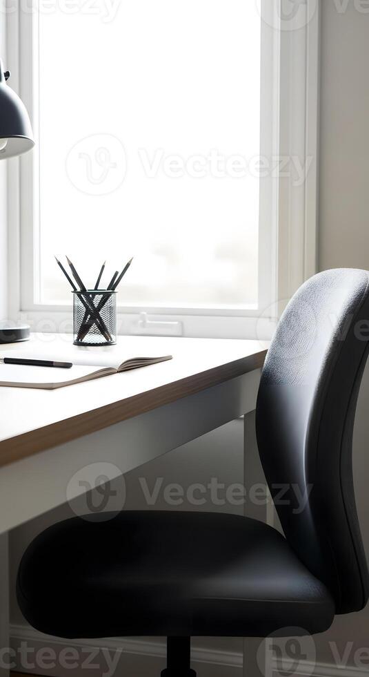 A black chair is sitting in front of a desk photo