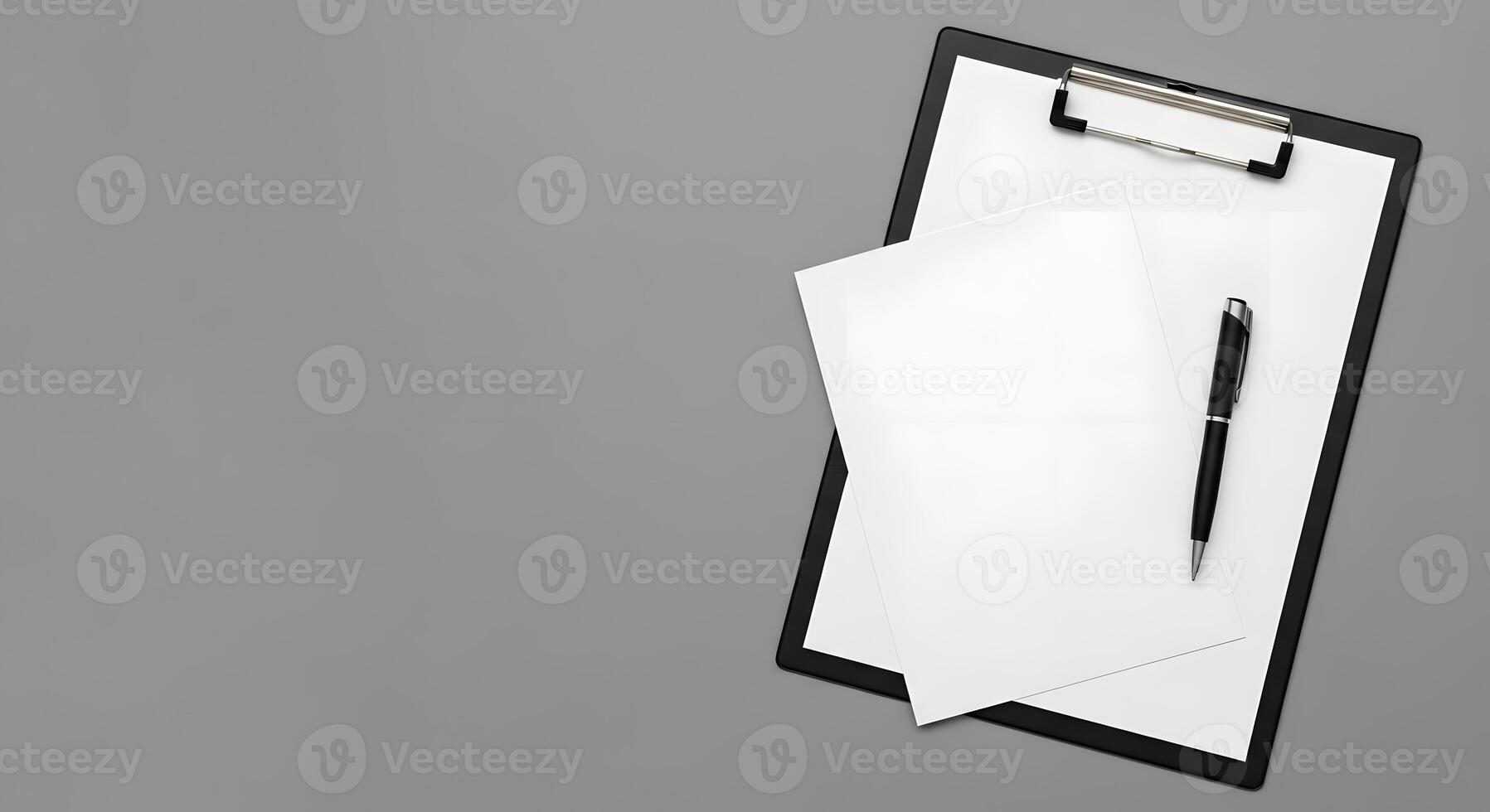 A clipboard with a pen and paper on top photo