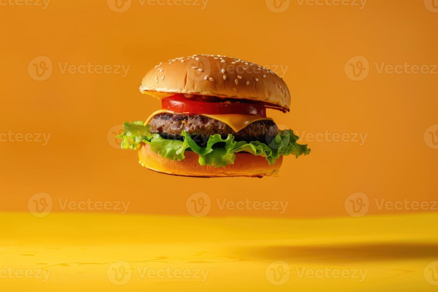A hamburger is flying in the air on a yellow background photo