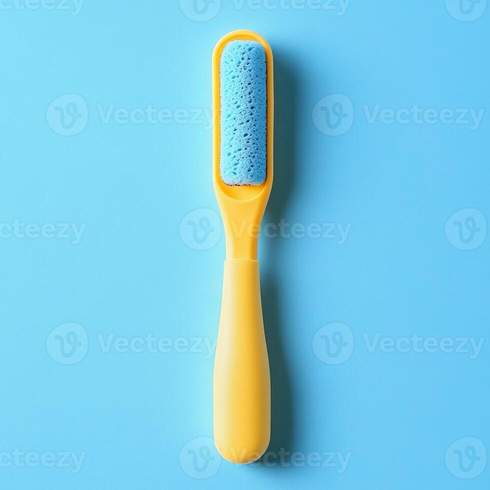 A yellow toothbrush with blue bristles on a blue background photo