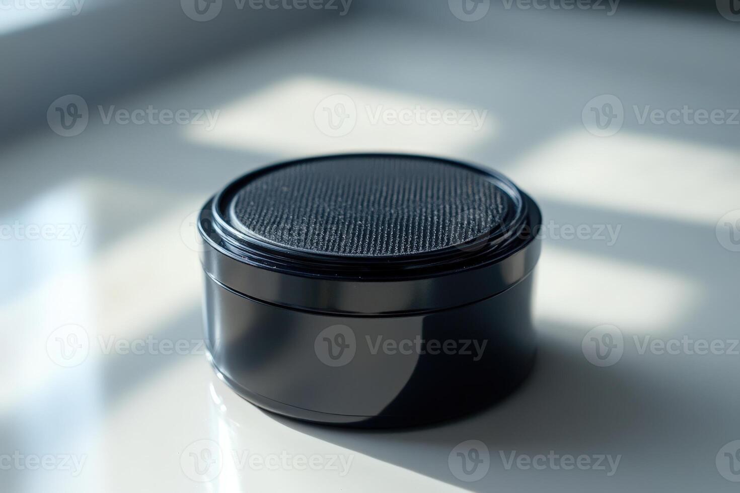 A black speaker sitting on a table photo
