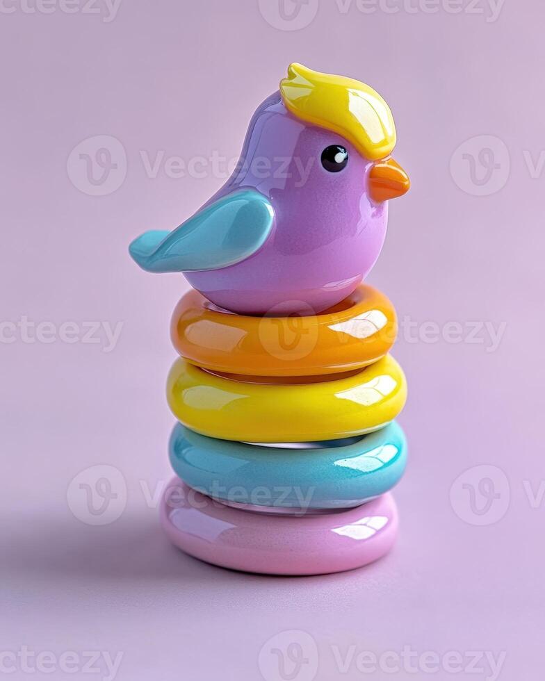 A colorful bird toy sits on top of a stack of rings photo