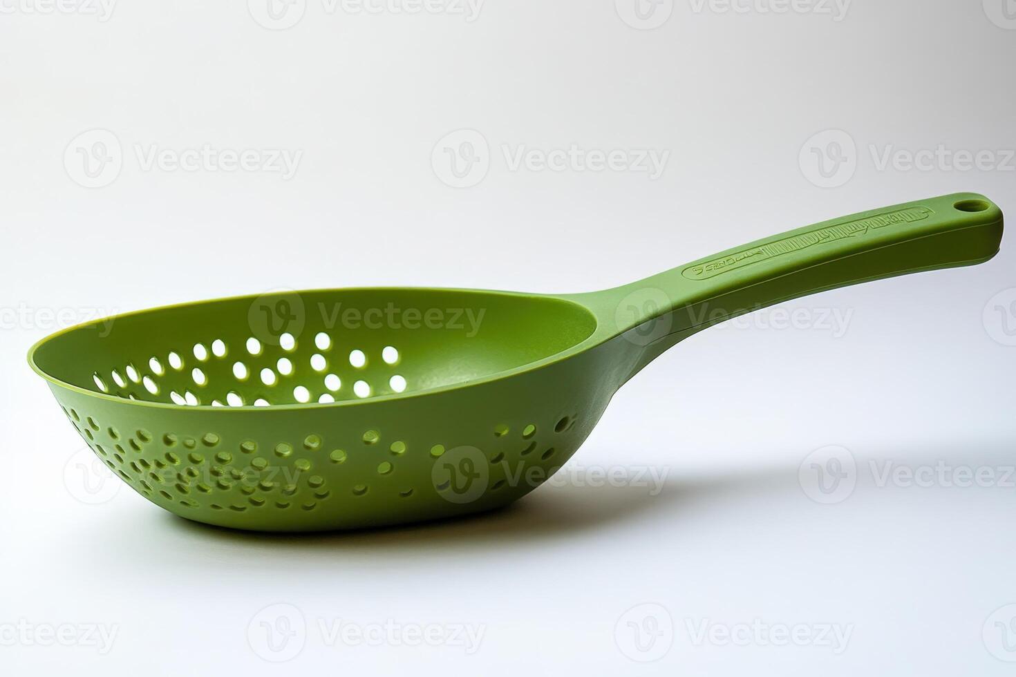 A colander with holes in it is green photo