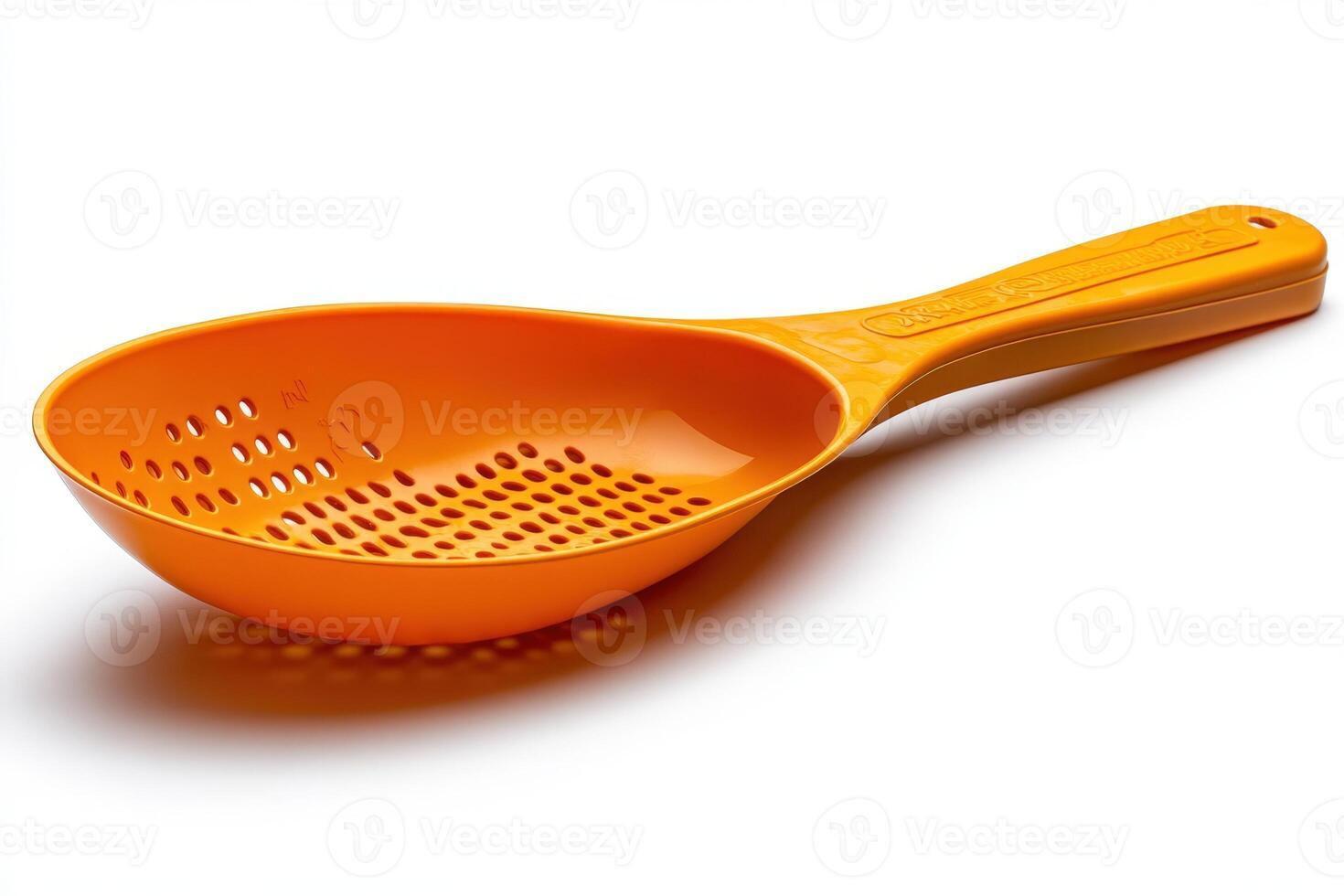 A plastic orange spoon with holes on it photo