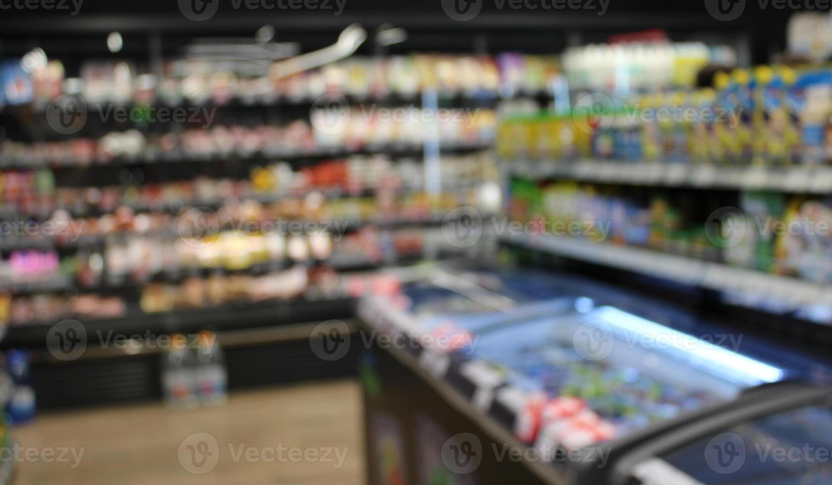 Refrigerators And Stalls With Goods In A Grocery Shop Defocused Stock Photo