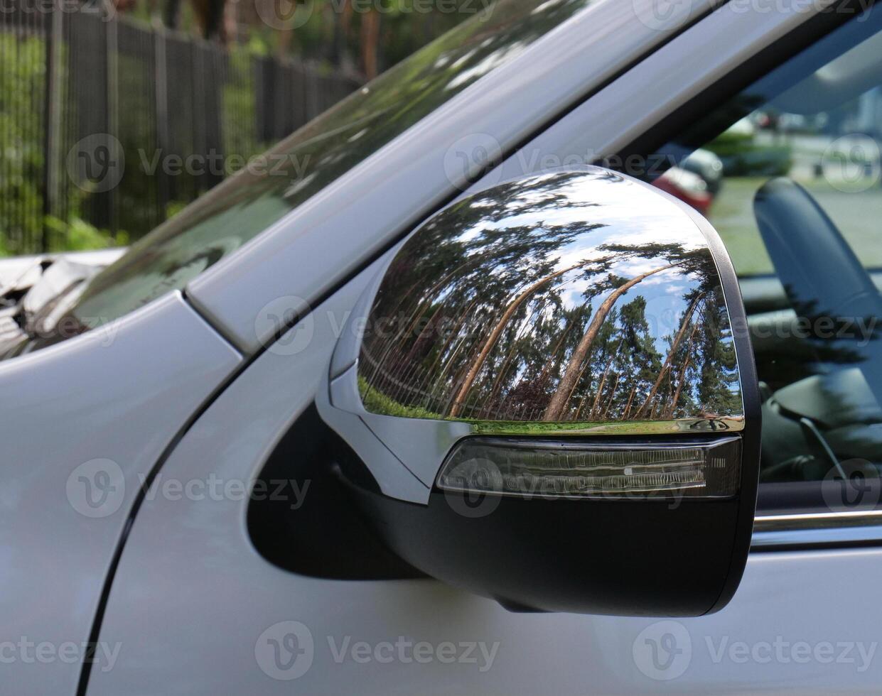 Closeup Photo Of Chrome Protection Panel On A Car Mirror With Reflection Of Trees