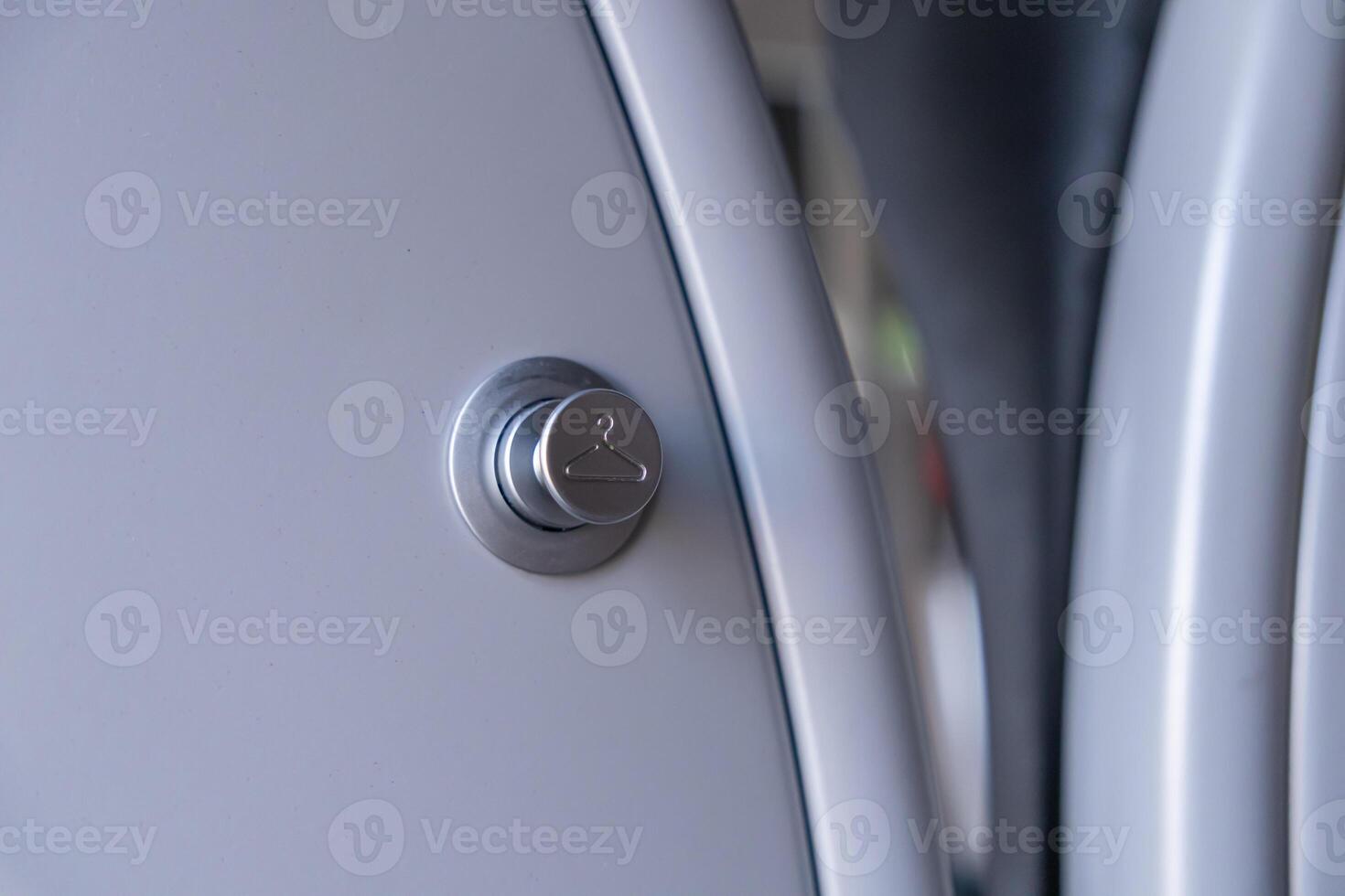 Contemporary silver button featuring a clothes hanger symbol, signifying smart laundry functionality for efficient garment care in modern home appliances photo
