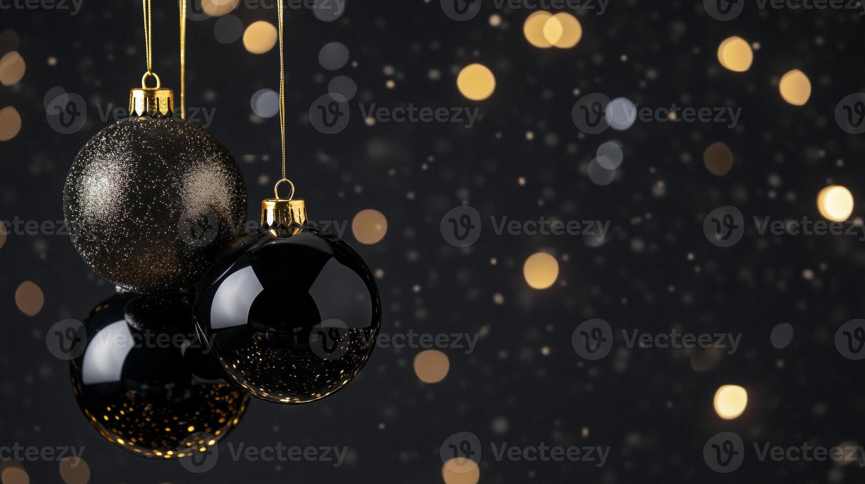 Glamorous black and gold Christmas baubles dangling from fine strings photo