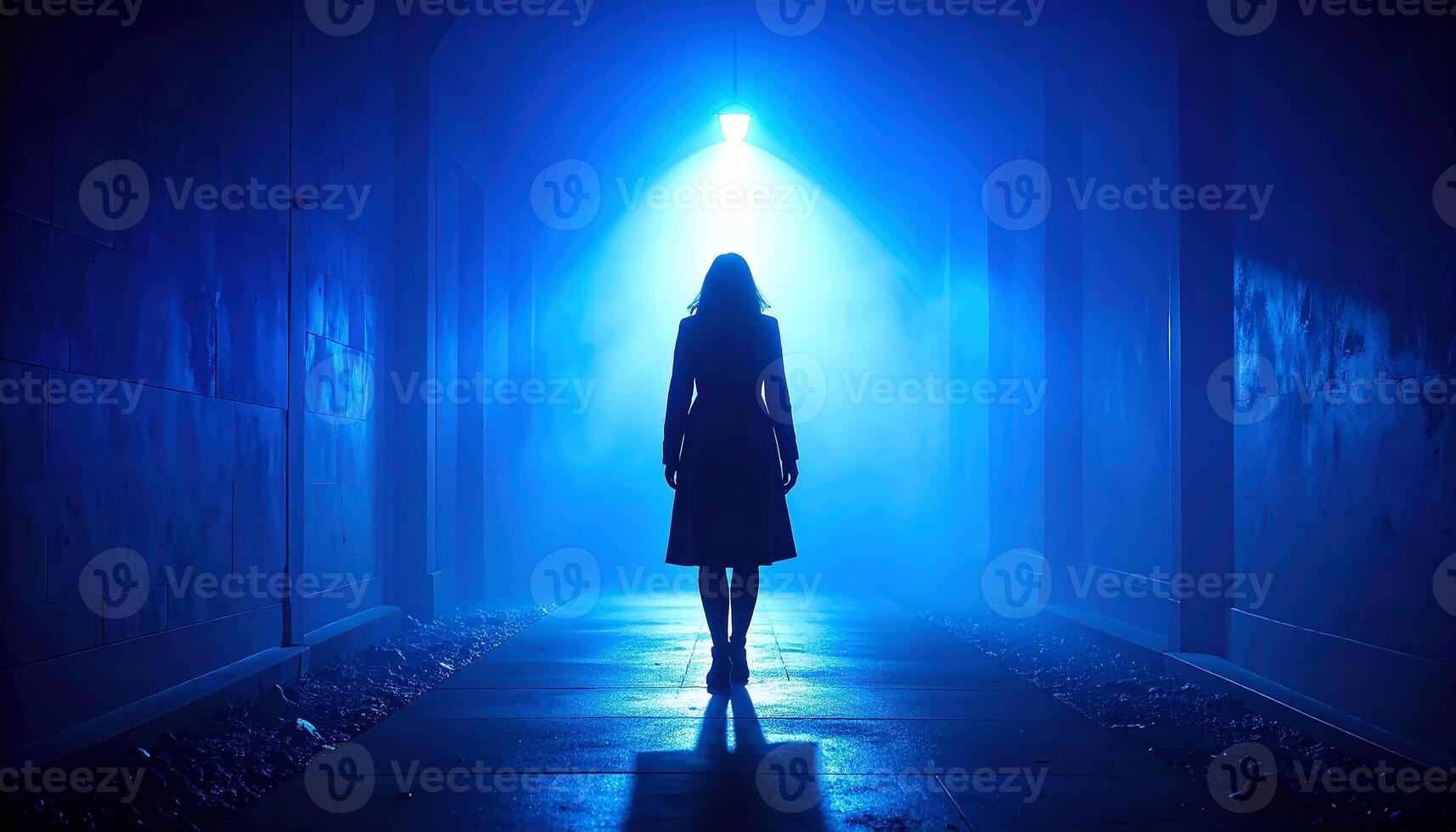 Lone Silhouette in a Foggy Tunnel Bathed in Mysterious Blue Light photo