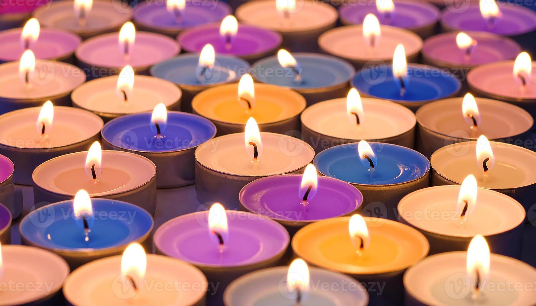 A Glowing Mosaic of Colorful Tealight Candles Burning Together photo
