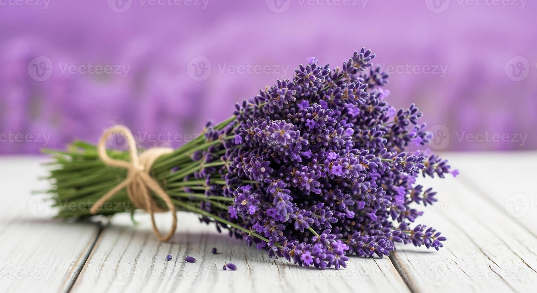 Fresh fragrant lavender bouquet on white wooden table with blurred background. photo