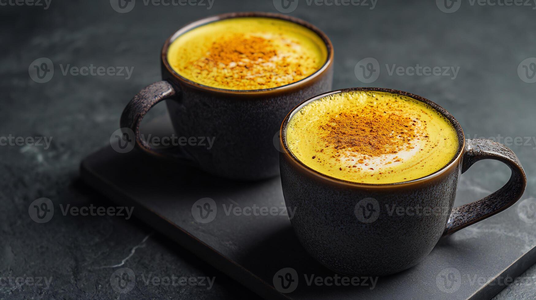 Two mugs of turmeric latte photo