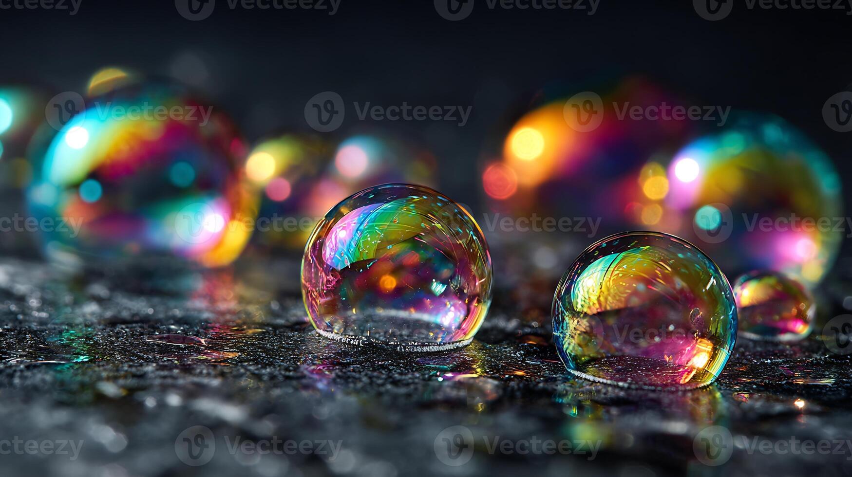 Vibrant soap bubbles reflecting a spectrum of colors on a dark surface. photo