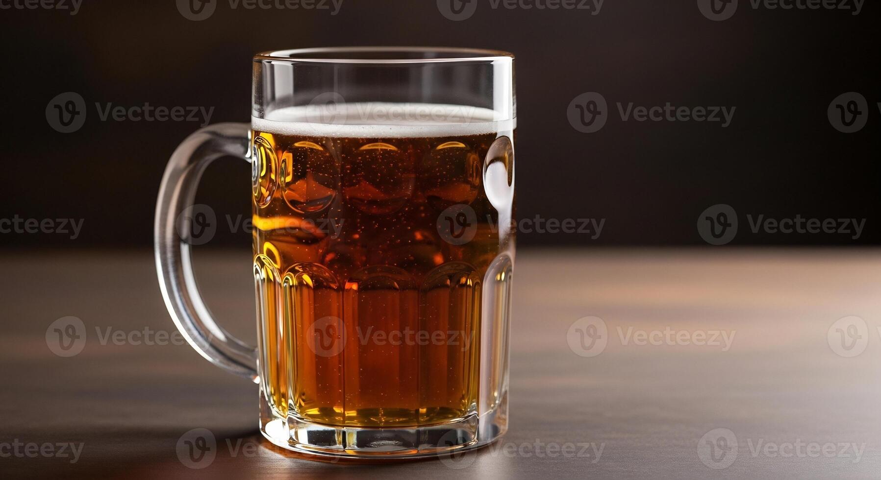 Refreshing amber beer in a classic glass mug, with foam, on a dark wooden table. photo