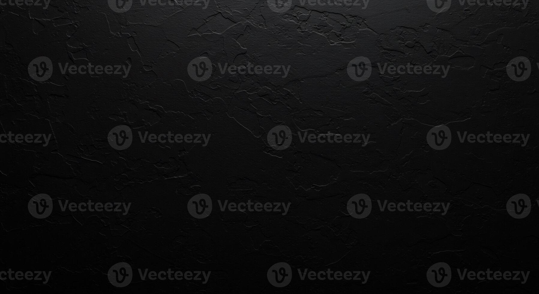 Black grunge background featuring an uneven, textured cement surface. photo