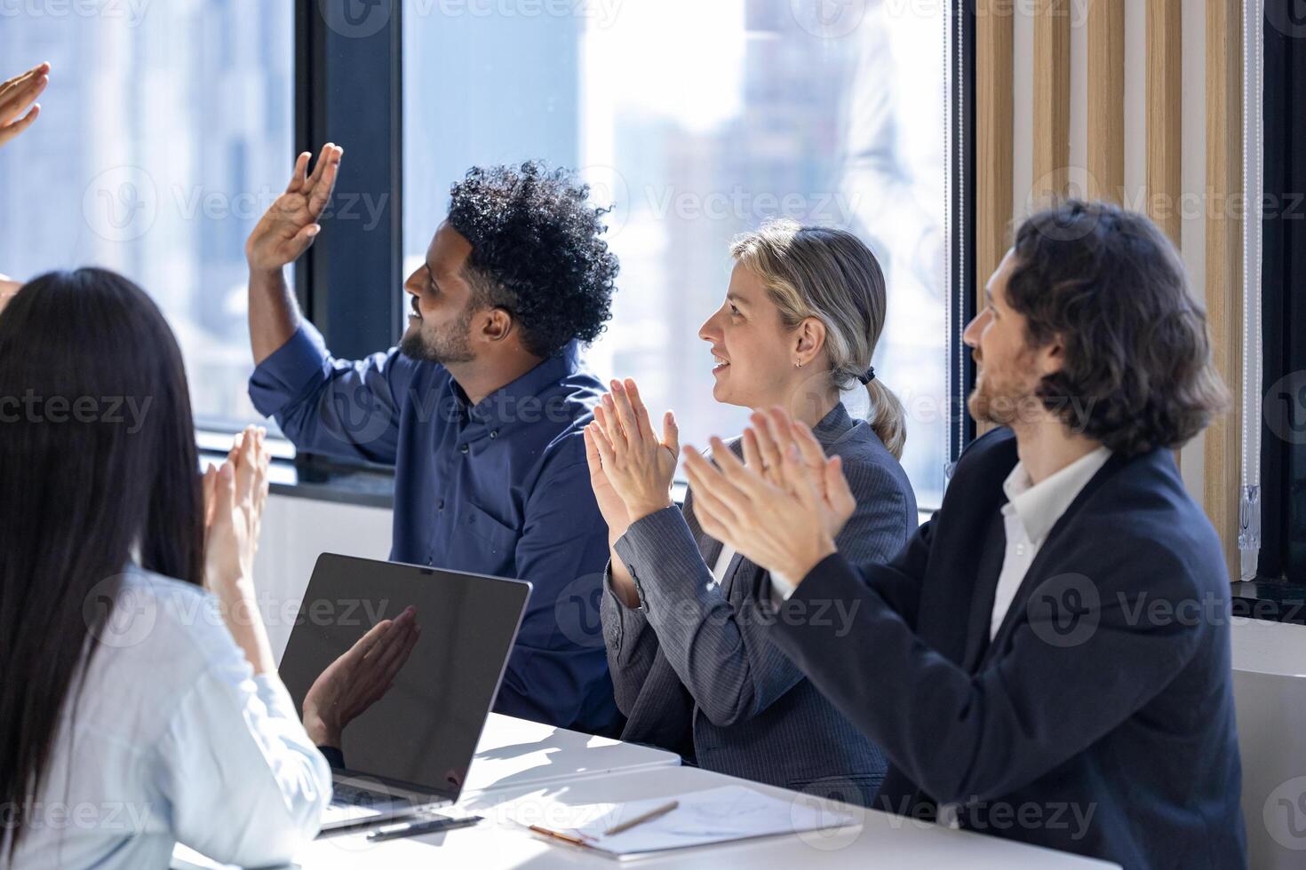 Team of happy diversity business people agreement on deal over new strategic strategy project on investment real estate with recognition and applause from other colleague for partnership photo