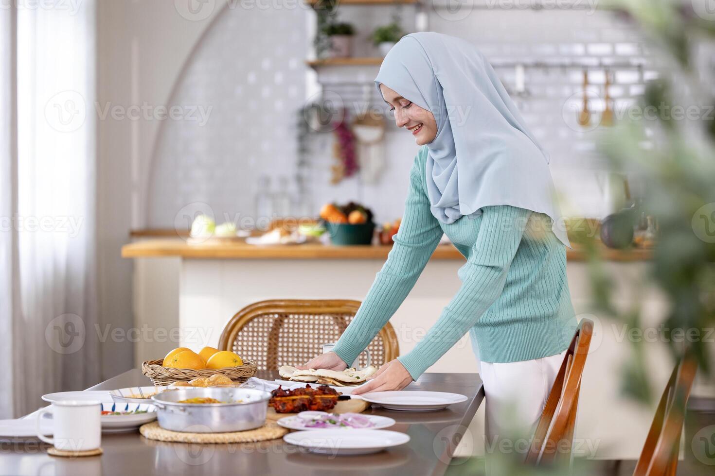 Middle eastern muslim lady in hijab is preparing food and dinner table arrangement for family feast at night during Eid Mubarak, Ramadan season with naan bread, biryani for culture and religion photo