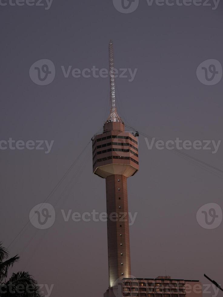 The Iconic Tower at Dusk A Beautifully Illuminated Landmark in the Cityscape at Night photo