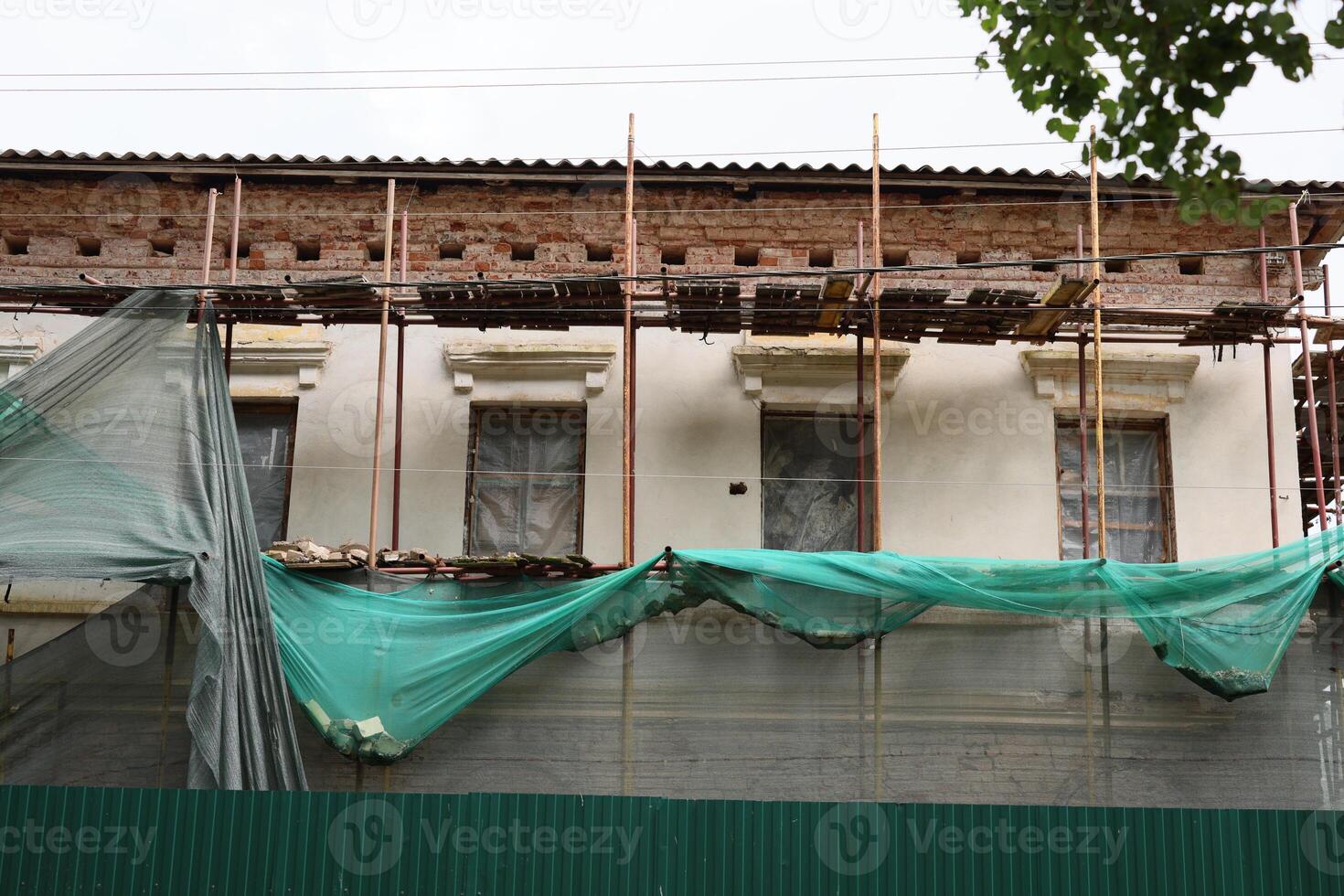 Building renovation requires scaffolding and protective cover for safety and efficiency photo
