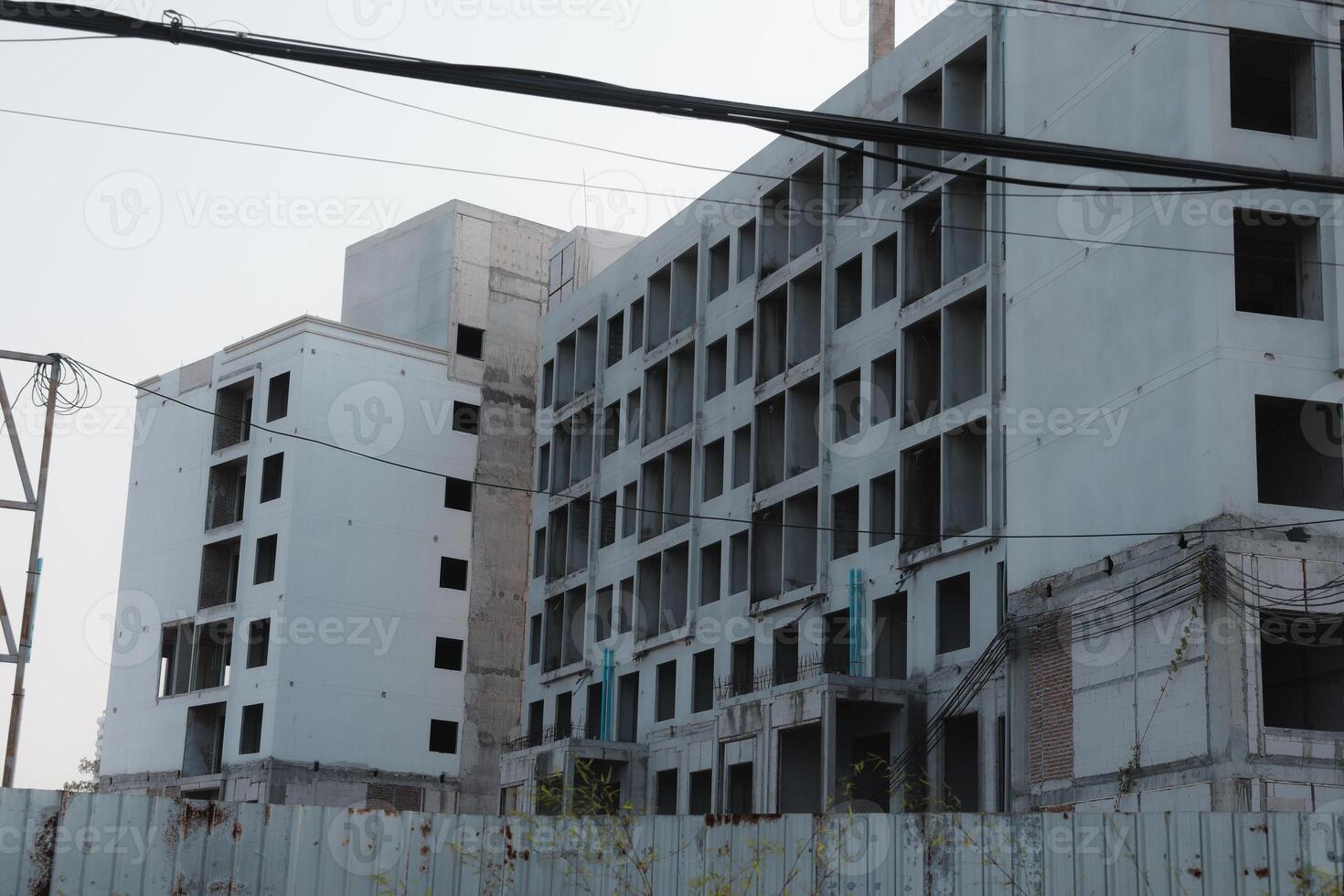 The site of abandoned construction characterized by incomplete and halffinished buildings photo
