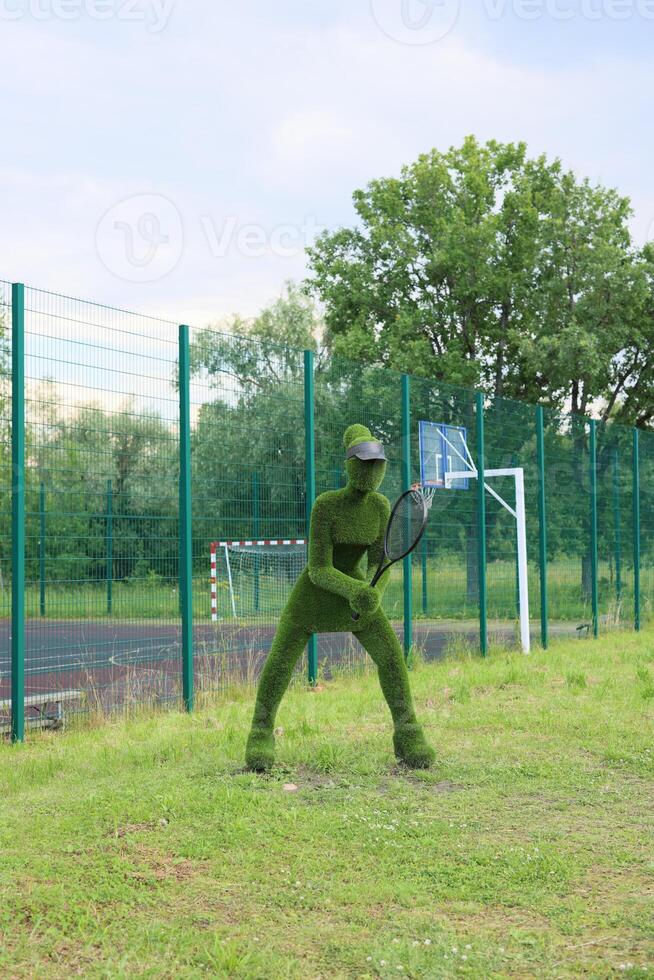 Energetic athlete in a vibrant green uniform engaged in playing tennis on an outdoor court photo