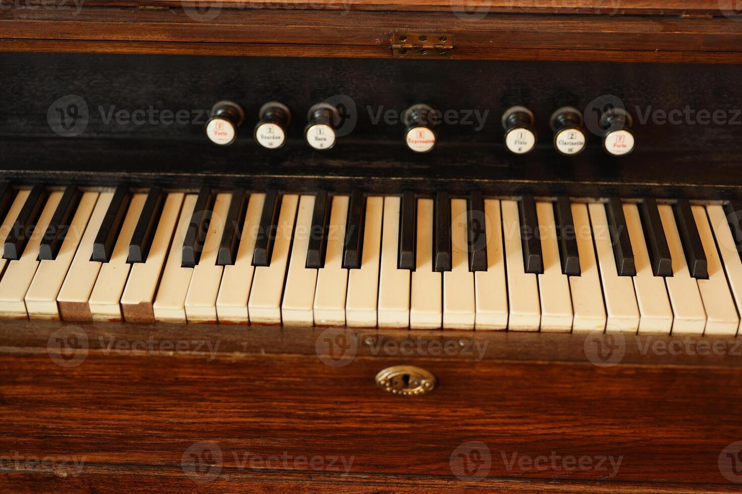 A beautifully designed Vintage Wooden Keyboard featuring both keys and stops for functionality photo