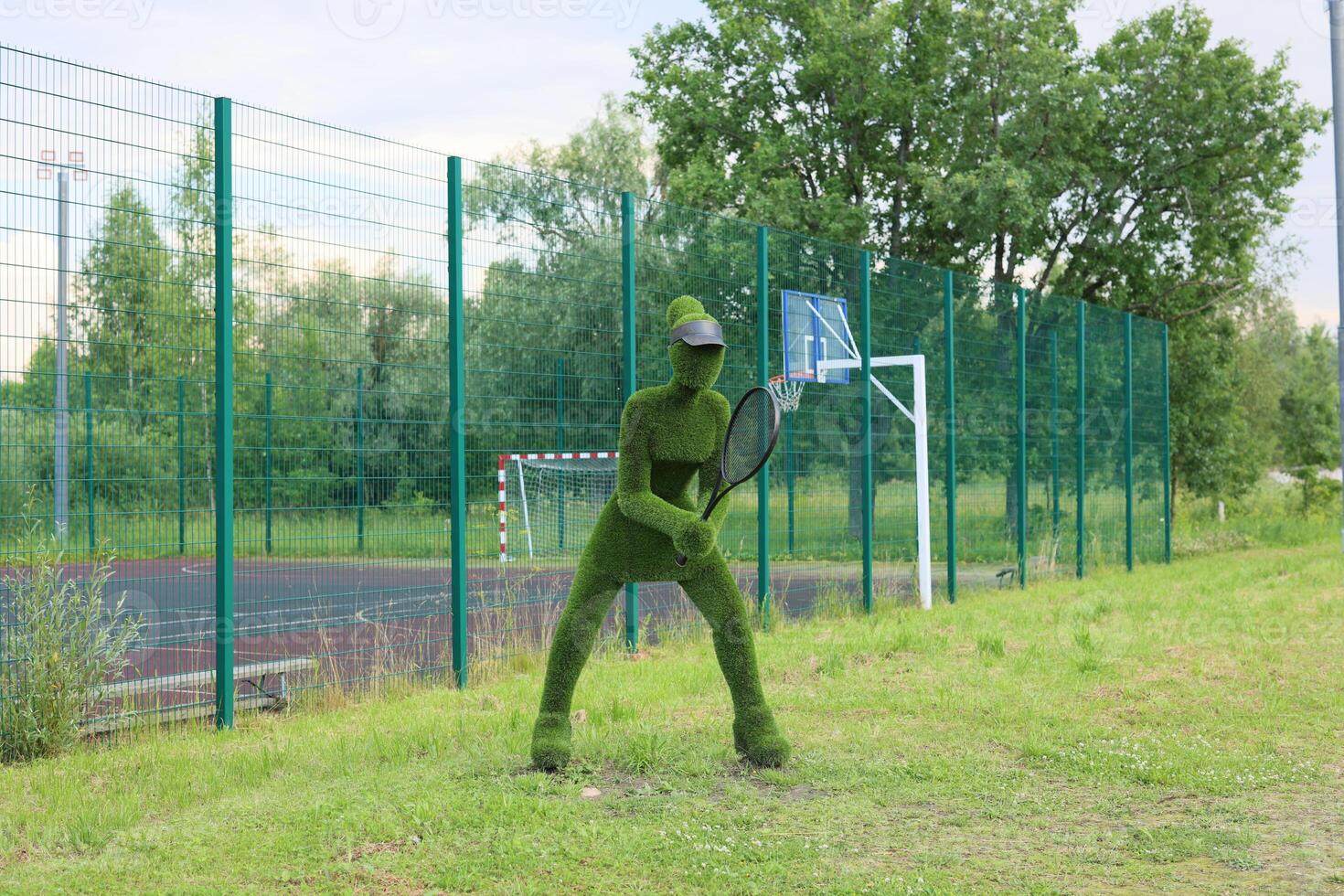 A Green Costume Player is actively engaging with others on an Outdoor Sports Field scene photo