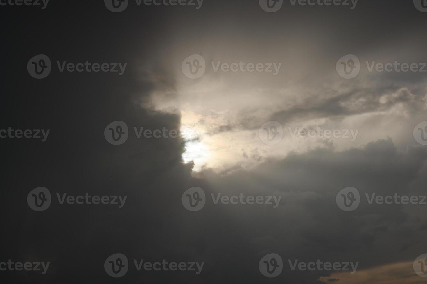 A Dramatic Sky with Sunlight Beautifully Peeking Through the Clouds, Creating an Epic Scene photo