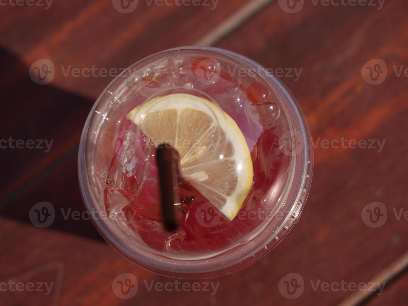 Enjoy a refreshing drink with a zesty lemon slice and a fun straw for satisfaction photo