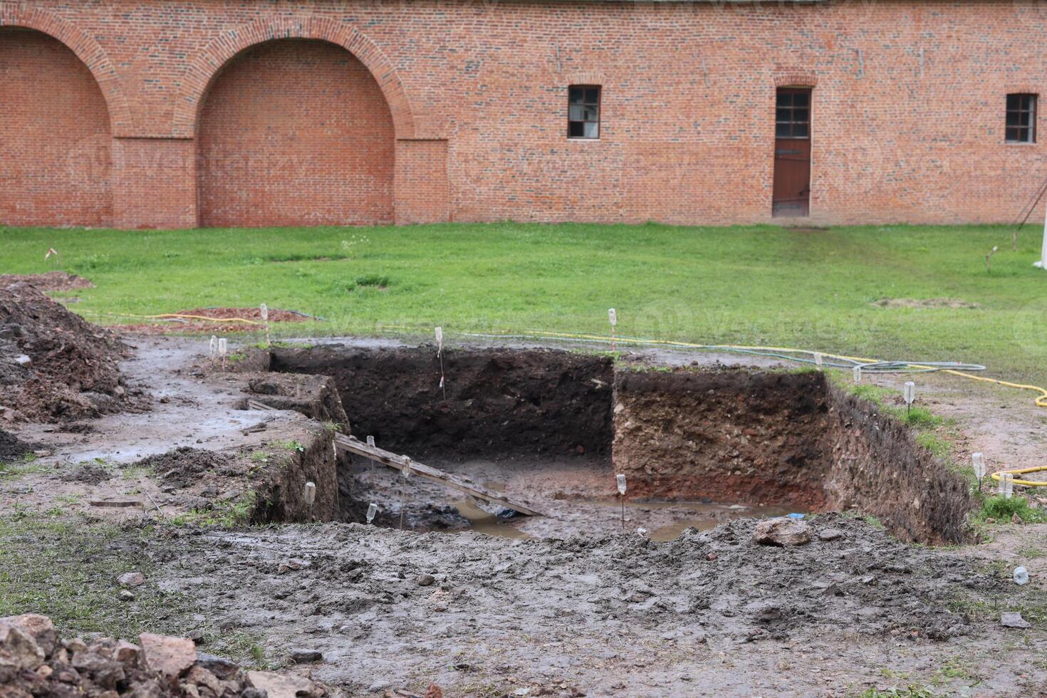 The archaeological excavation site located behind the brick building is of great significance photo