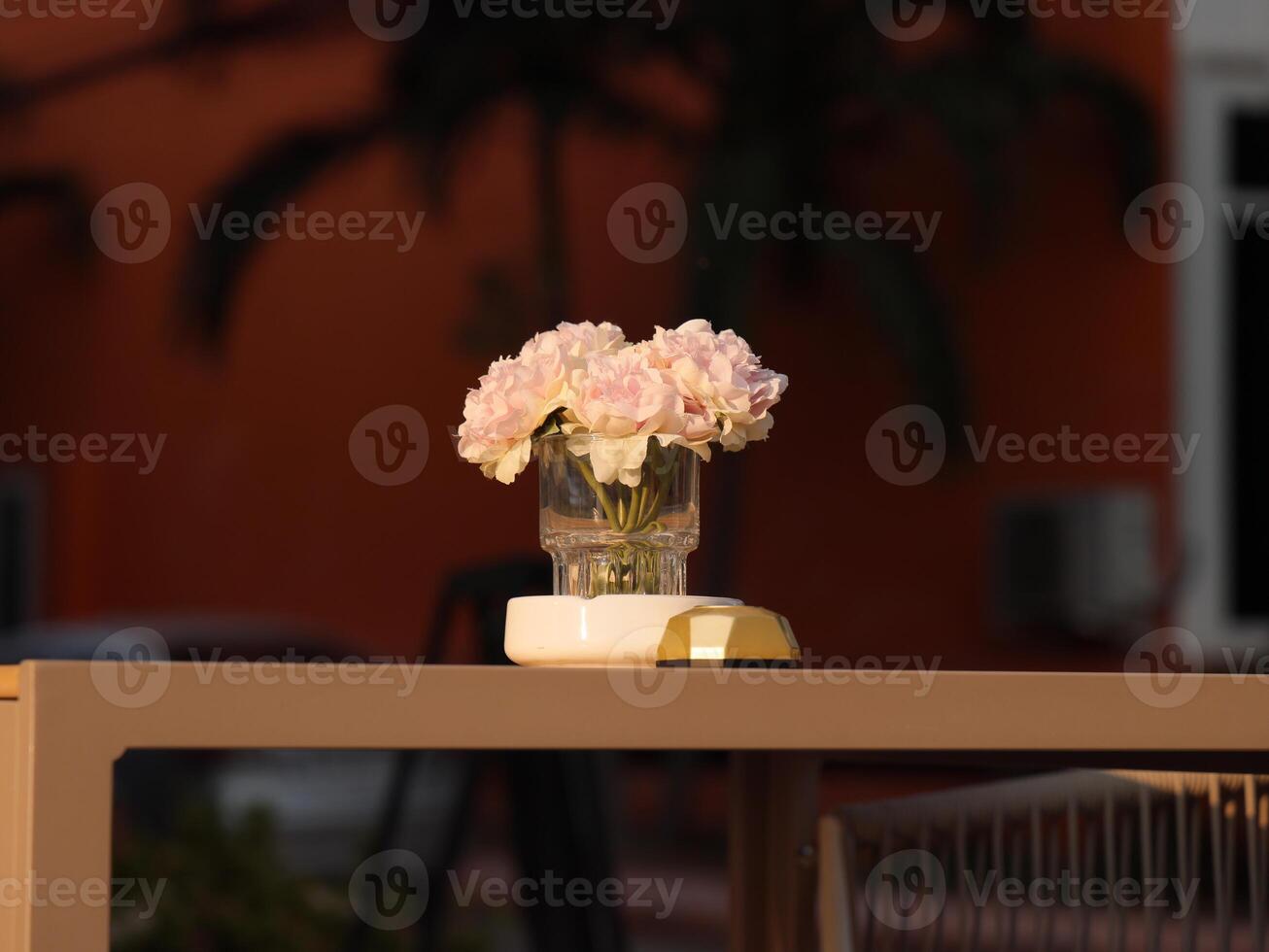 An Elegant Floral Arrangement is Beautifully Placed on a Table in a Picturesque Outdoor Setting photo