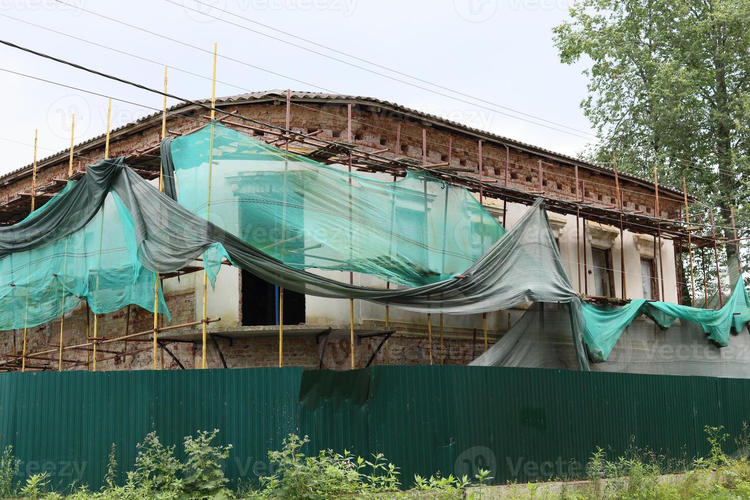 A construction site featuring safety netting and scaffolding for ongoing building projects photo