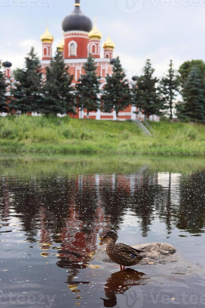 Idyllic and beautiful reflections of a historic church situated by the waters edge photo