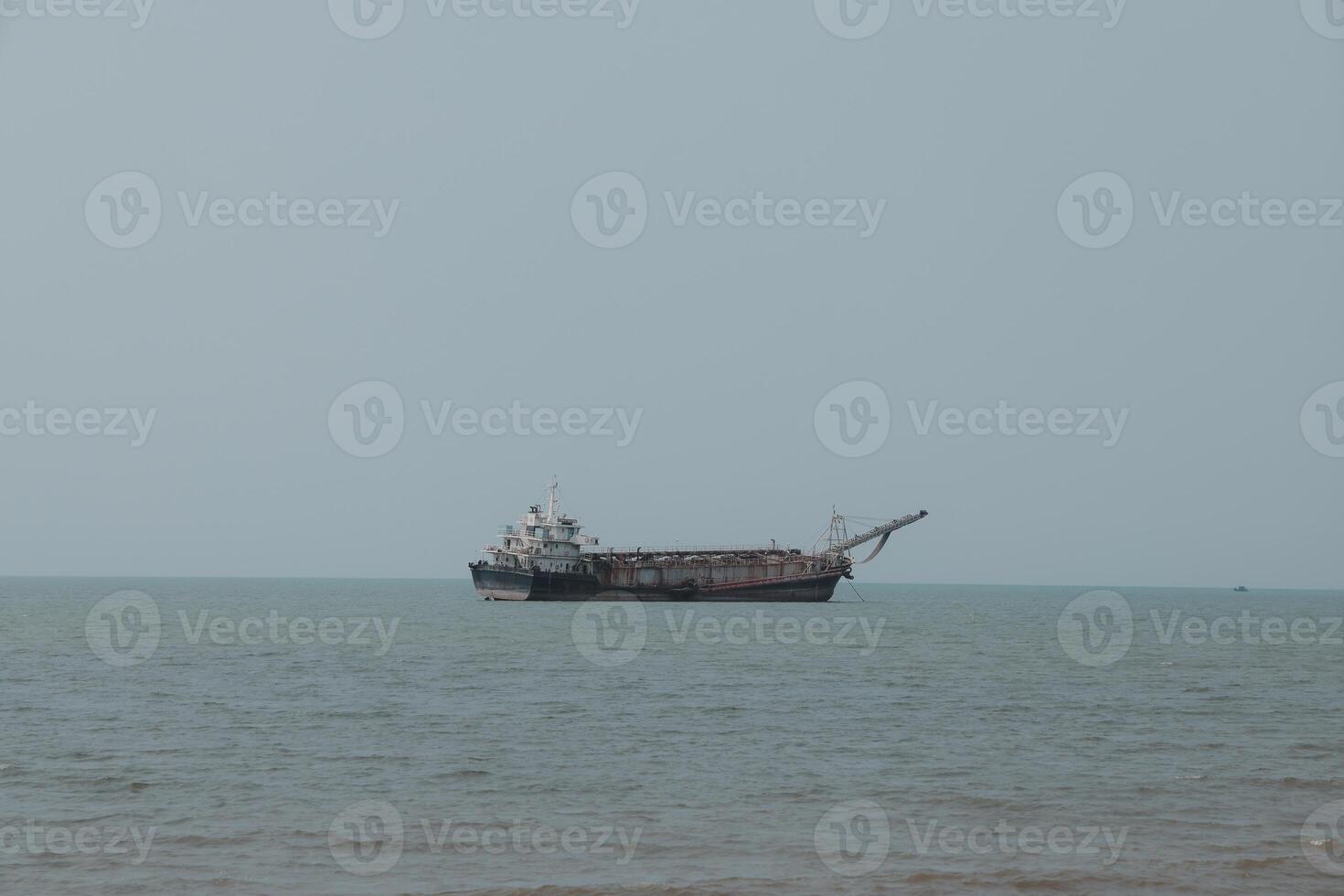 A Cargo Ship is Steadily Navigating Through the Calm and Tranquil Waters of the Ocean photo