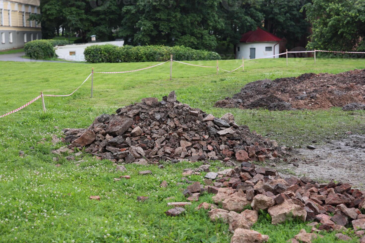 Excavation Site with Numerous Piles of Broken and Crumbling Bricks and Debris Nearby photo