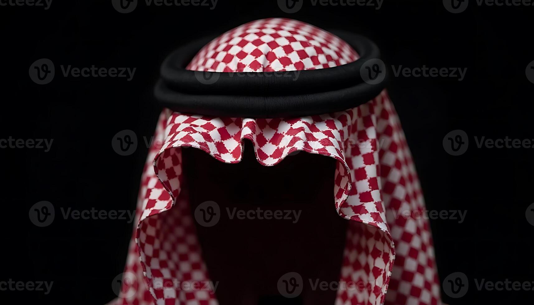 Arab Headdress Red Checkered Pattern with Black Band on Dark Background photo