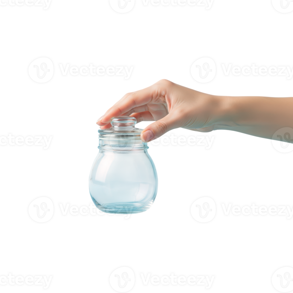 A hand gently holds a small clear glass jar with a lid suggesting storage or a png