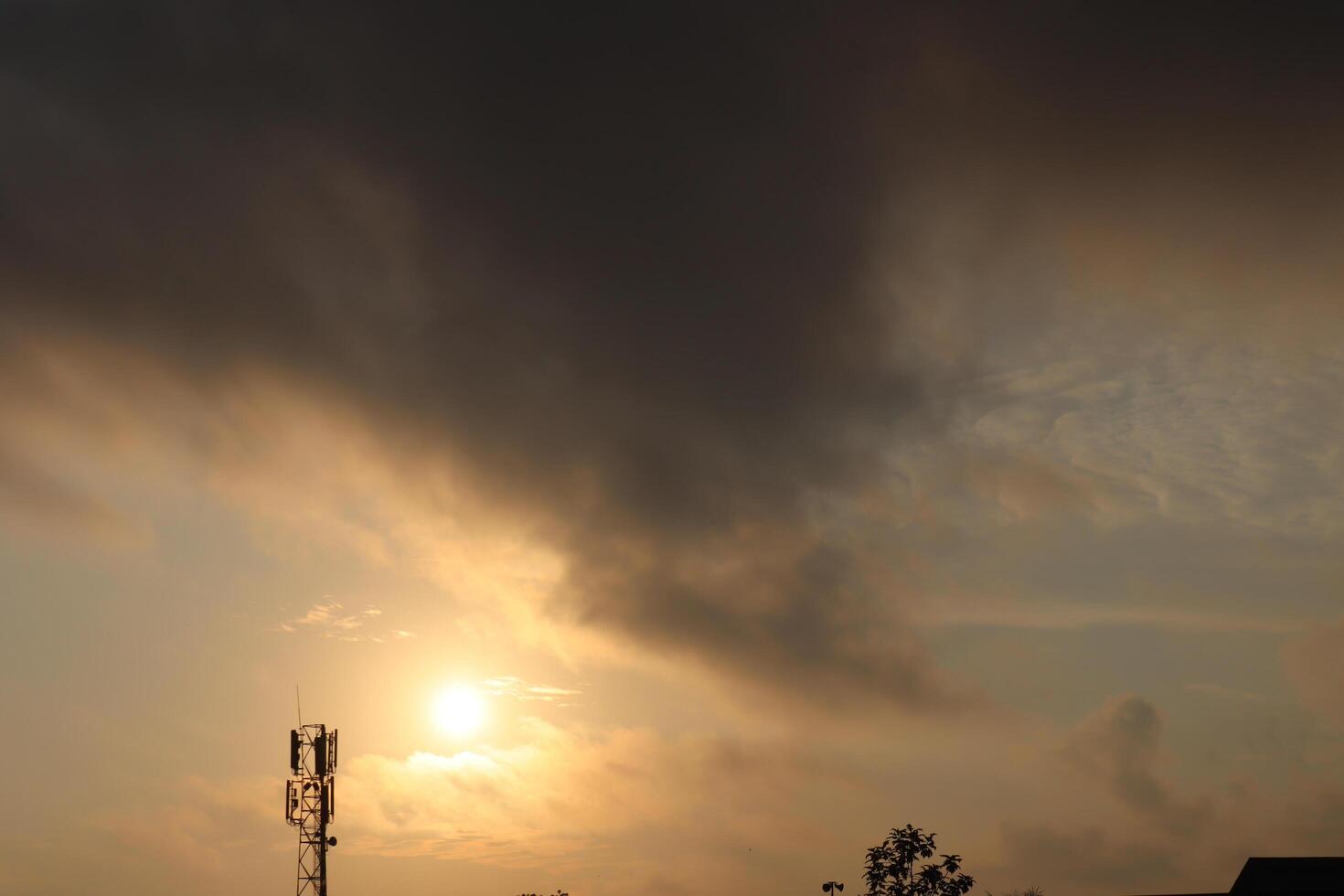 Sun shining through scattered clouds in a sky transitioning photo