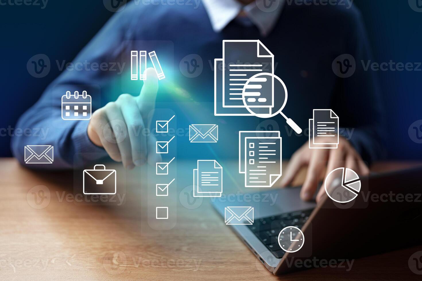 Digital workspace with a man interacting with virtual icons on a laptop during a productive session photo