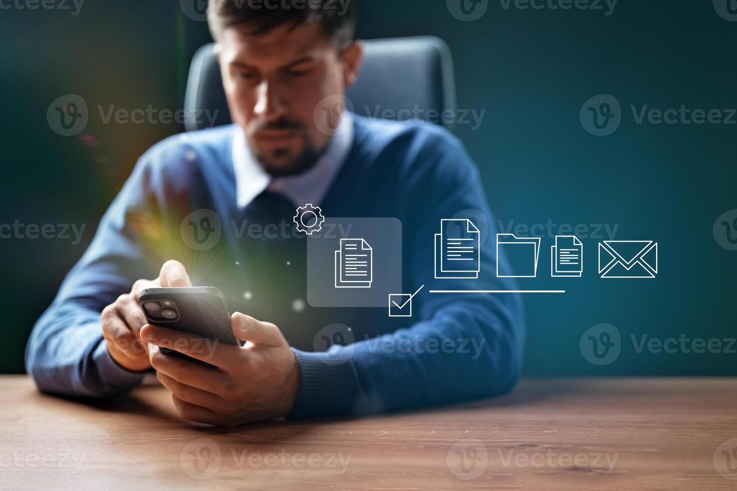 Professional man using smartphone to manage documents and communications in office environment photo