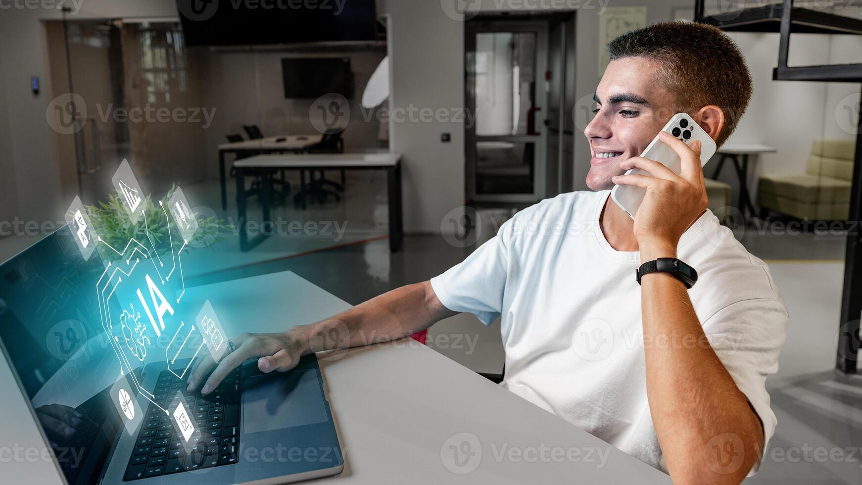 Young man engages with artificial intelligence technology while using laptop and smartphone in modern workspace photo