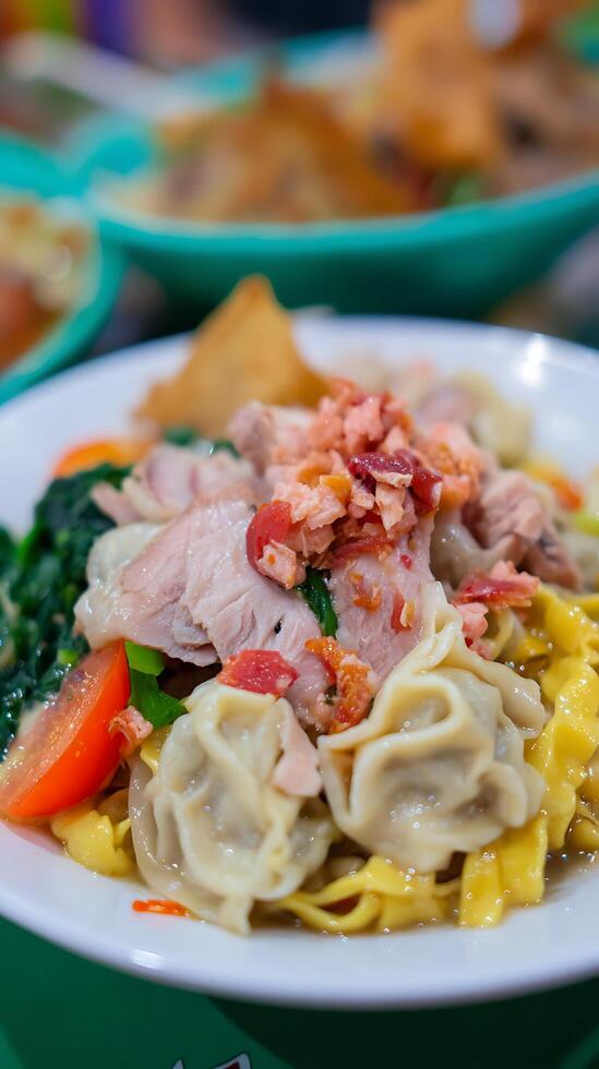 Delicious Asian Noodle Soup with Pork and Dumplings. photo
