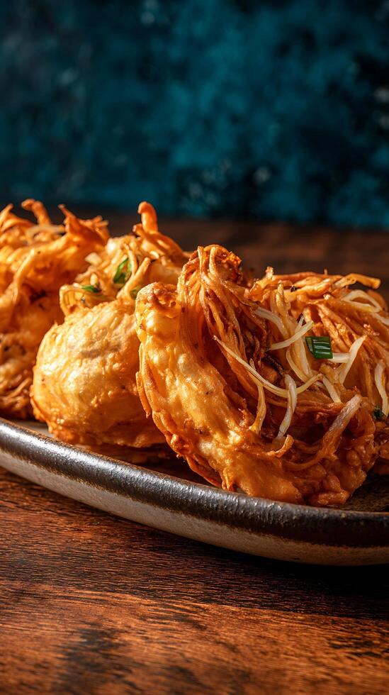 Golden Fried Onion Fritters Crispy Appetizer Delight on Dark Plate. photo