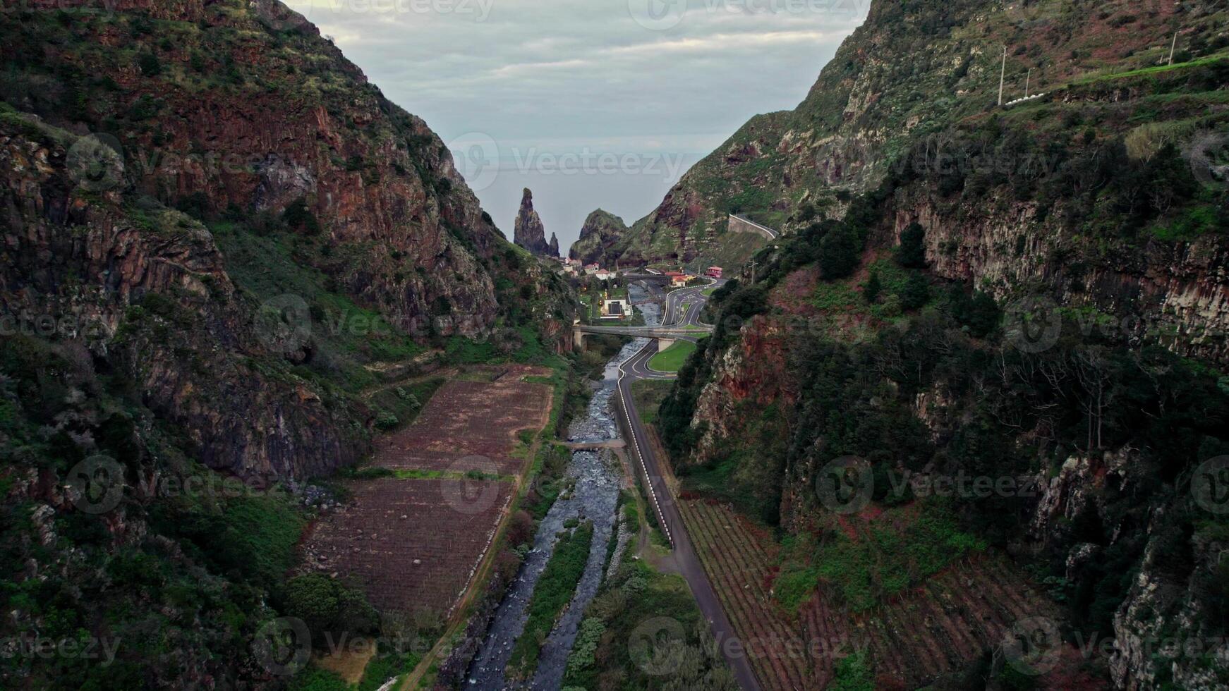 Aerial view of a narrow valley with a river running through it photo