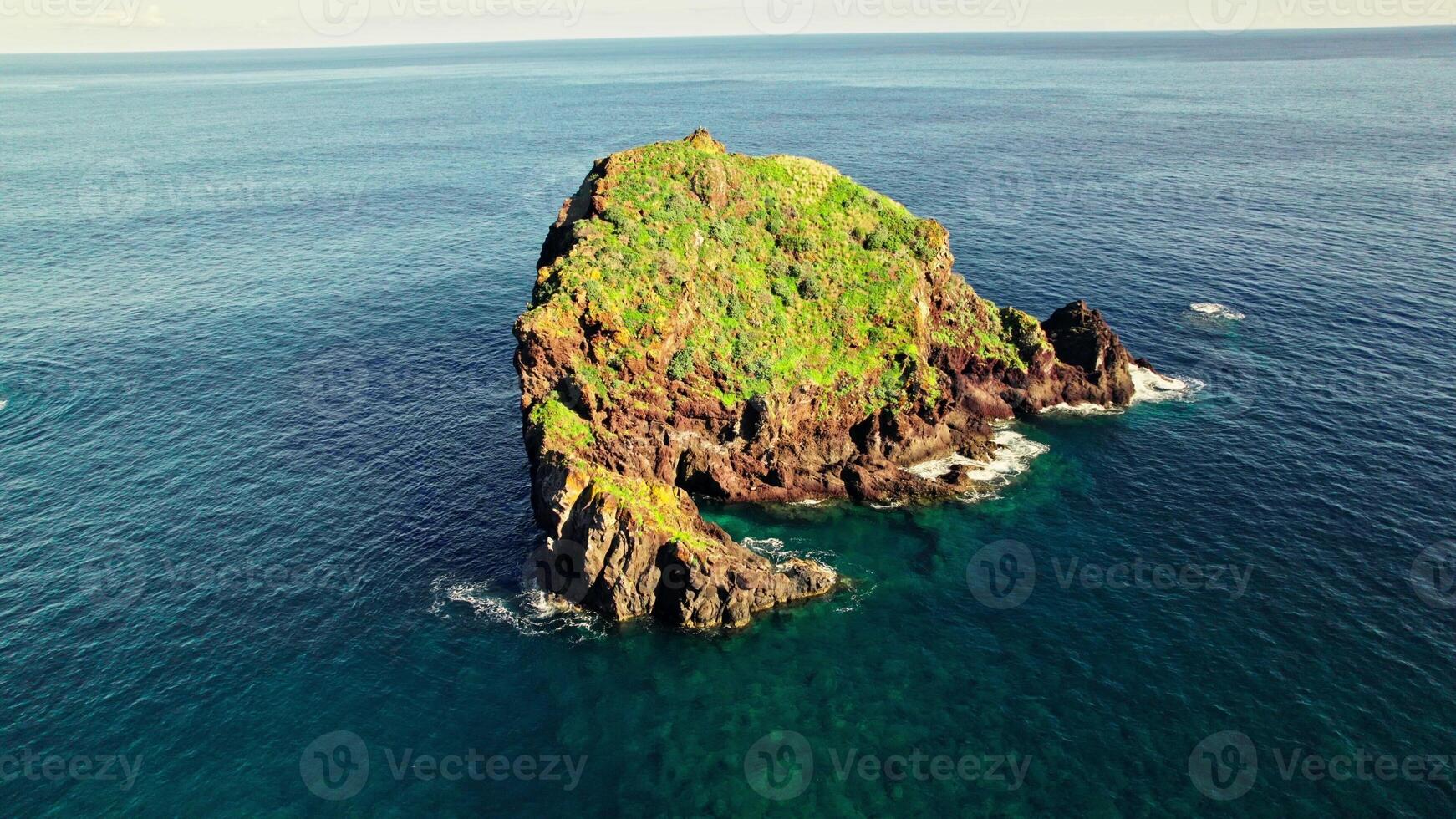 An aerial view of a rock in the ocean photo