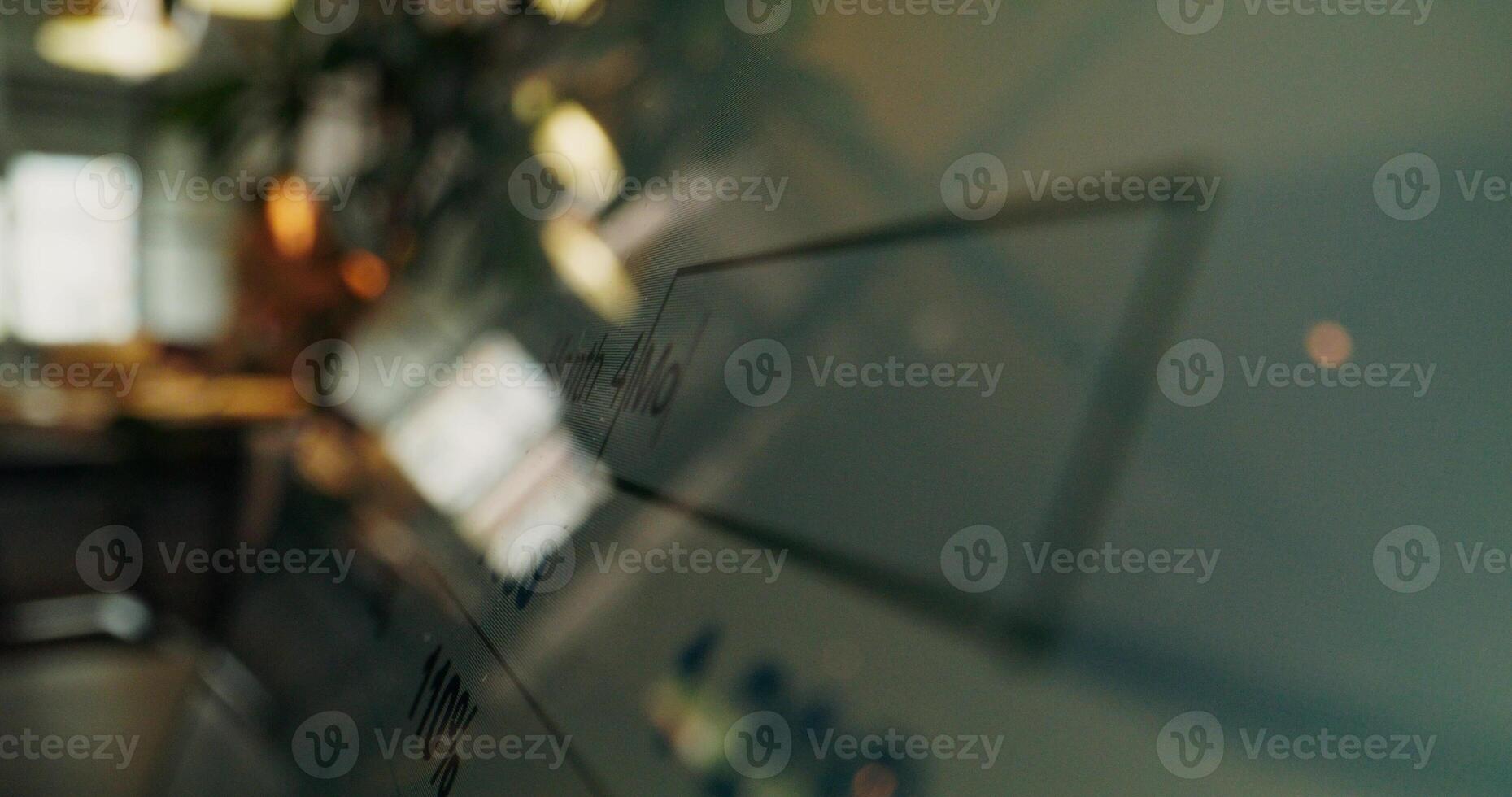 A close up of a glass wall with a computer screen photo