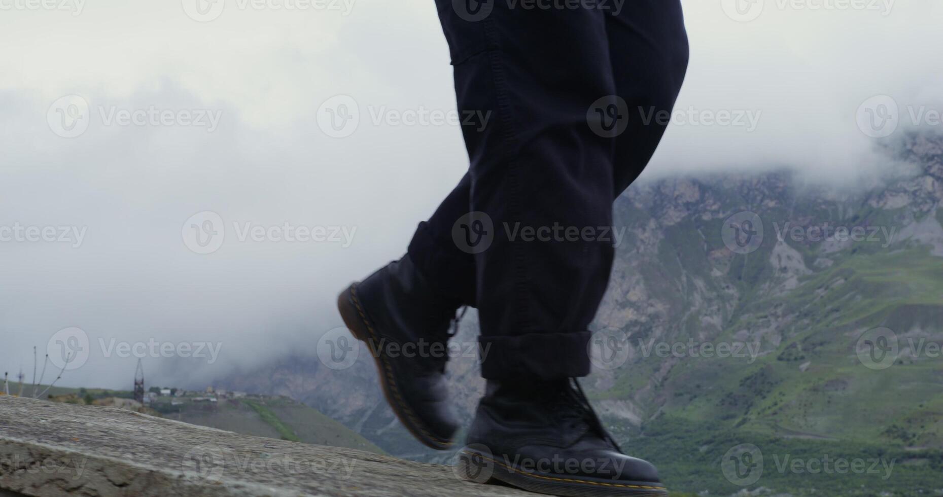 A person wearing black shoes photo
