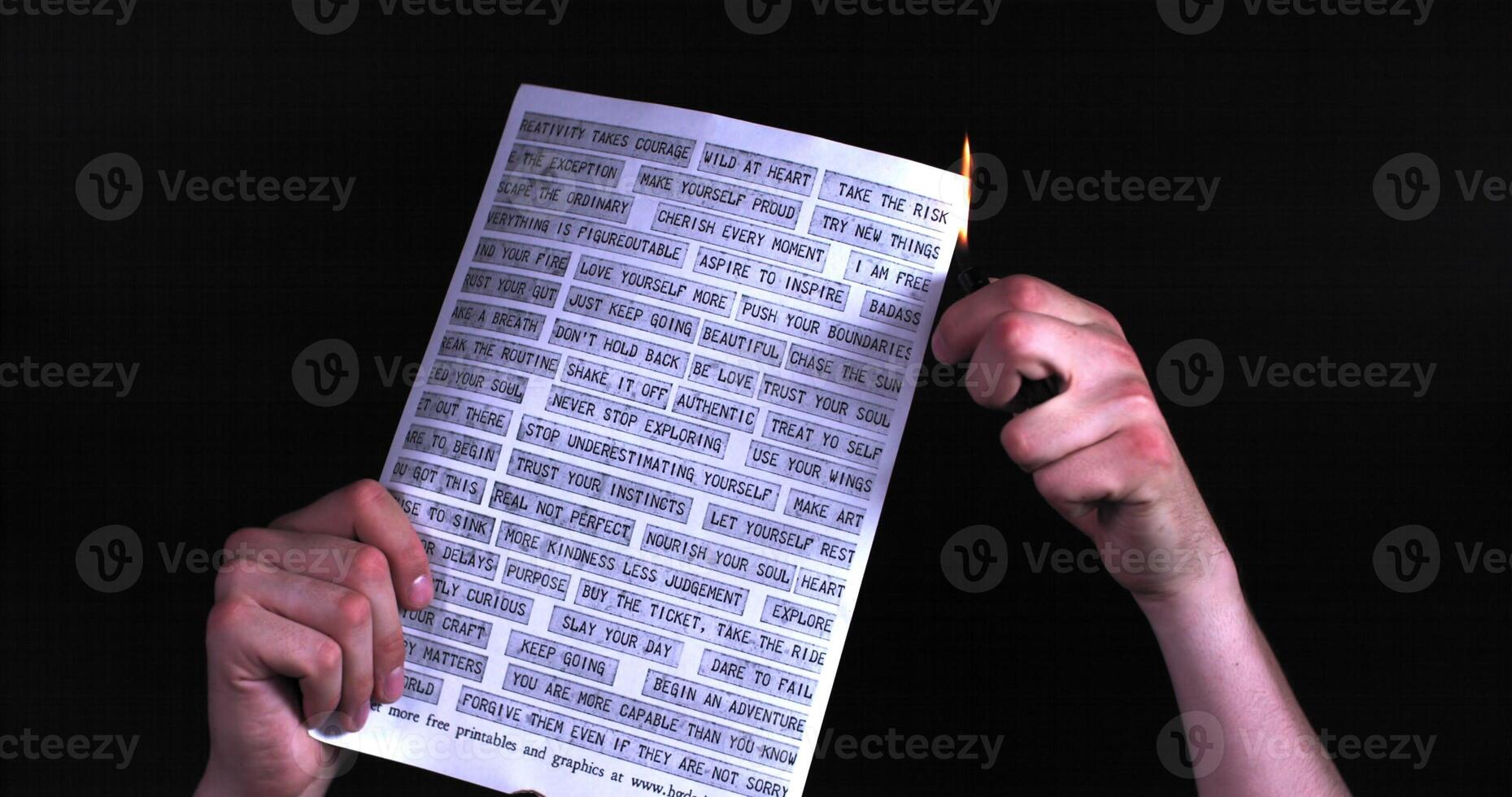 A person holding a piece of paper with a pencil photo