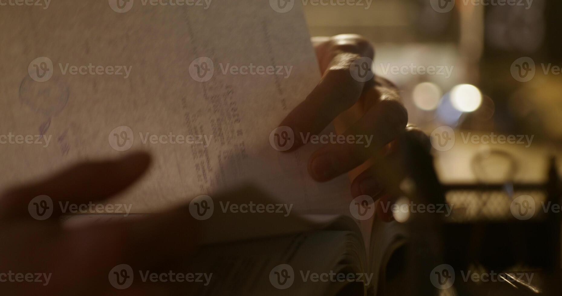 A person holding a piece of paper with a pen in their hand photo