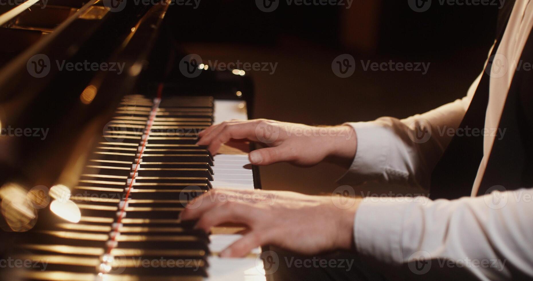 A person is playing the piano with their hands photo